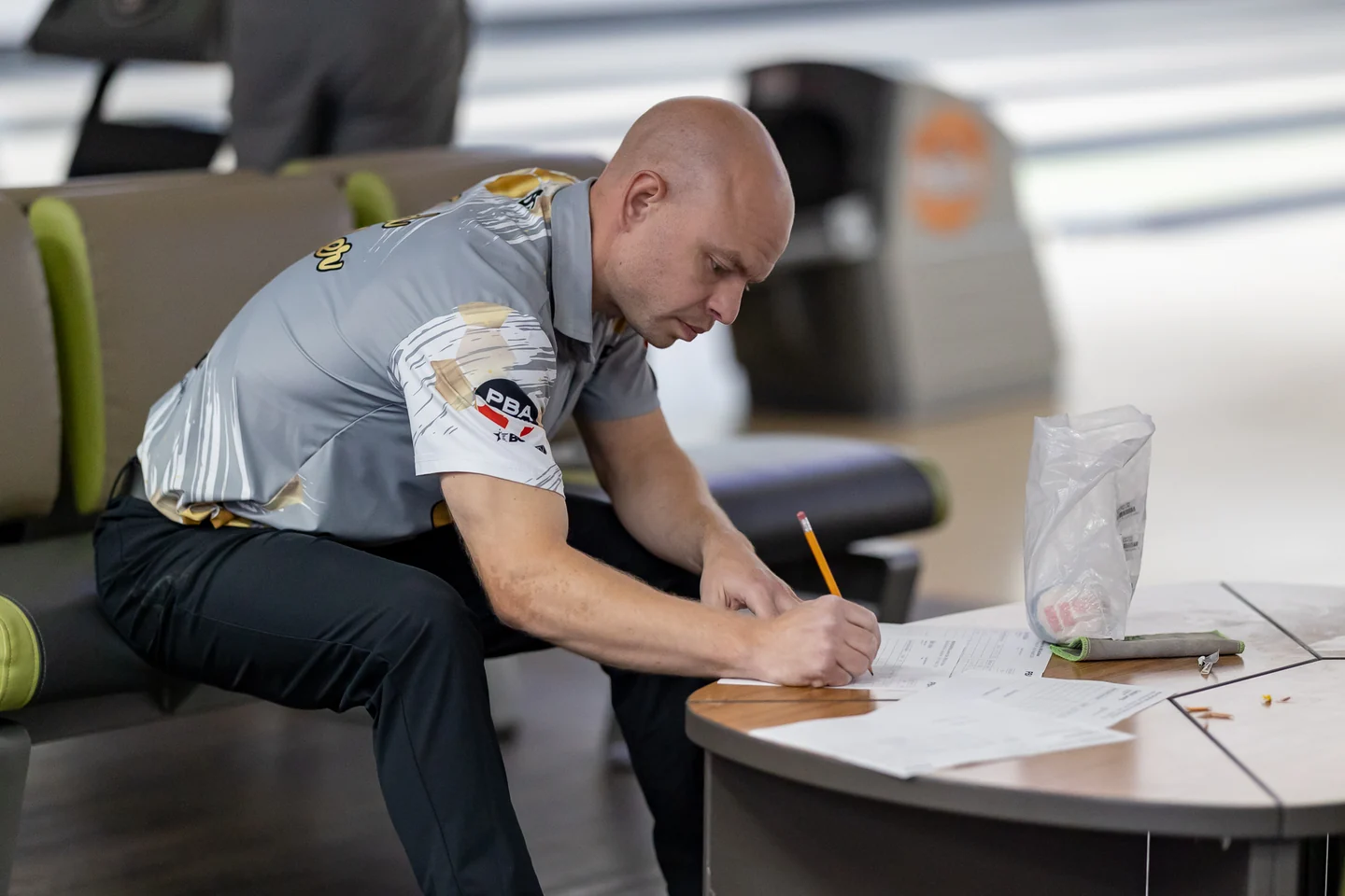 Brad Miller sitting at the lanes, working through his notes with a pencil